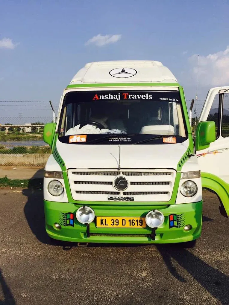 Front view of an Anshaj Travels tempo traveller