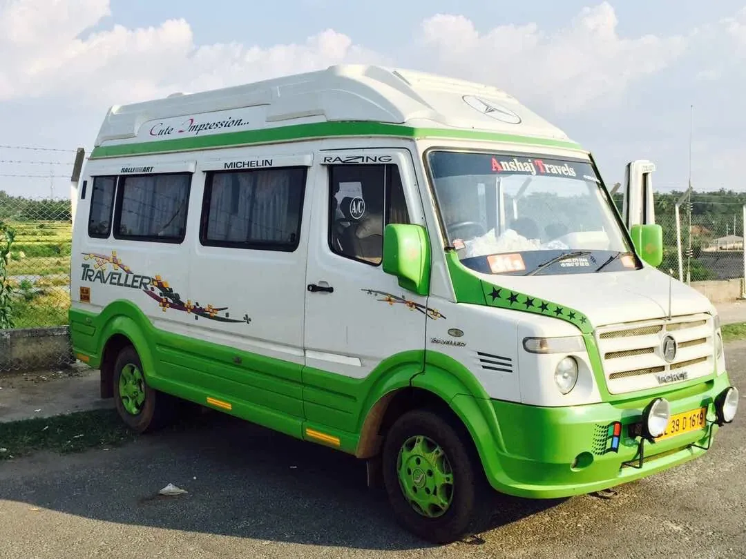 Anshaj Travels white and green Force Traveller tempo traveller