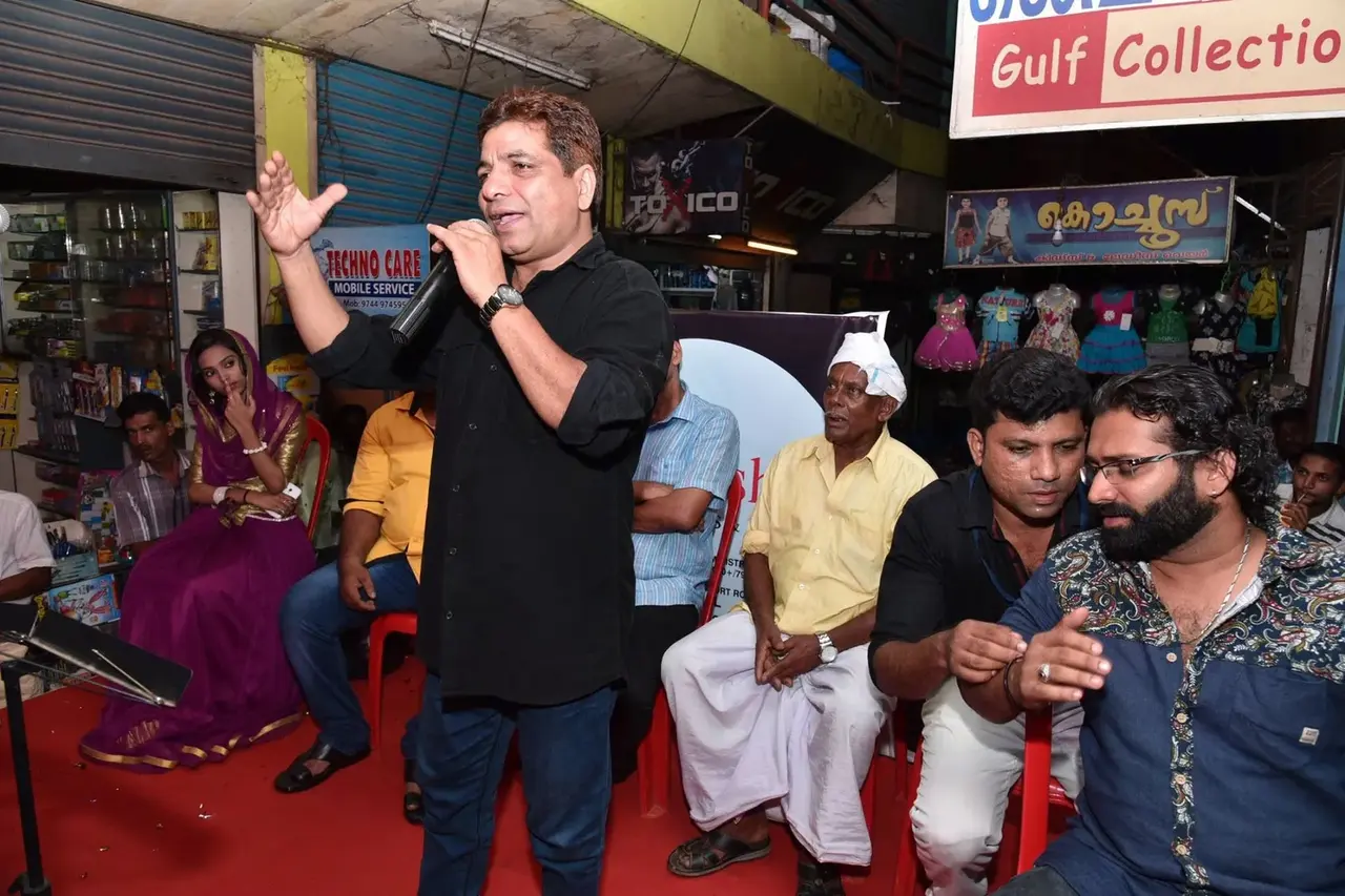 Guest speaking into a microphone at the Anshaj inauguration