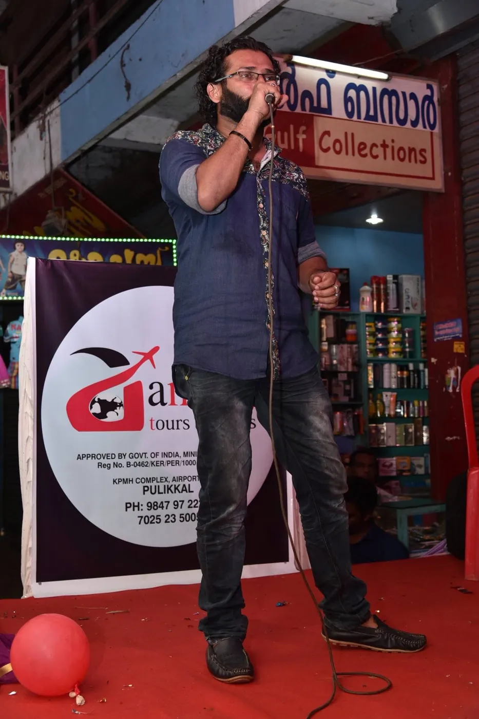 Singer performing on stage in front of the Anshaj banner