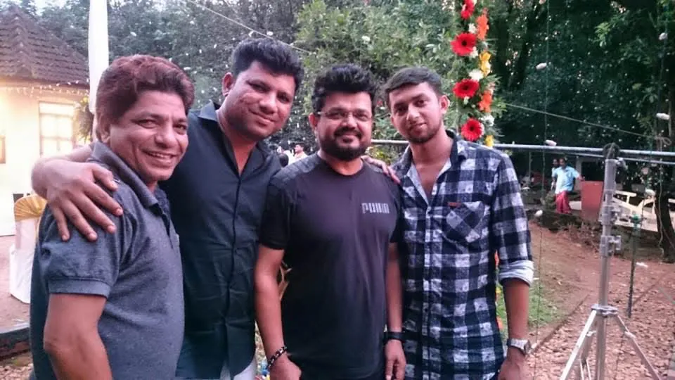 Four friends smiling together at an outdoor celebration