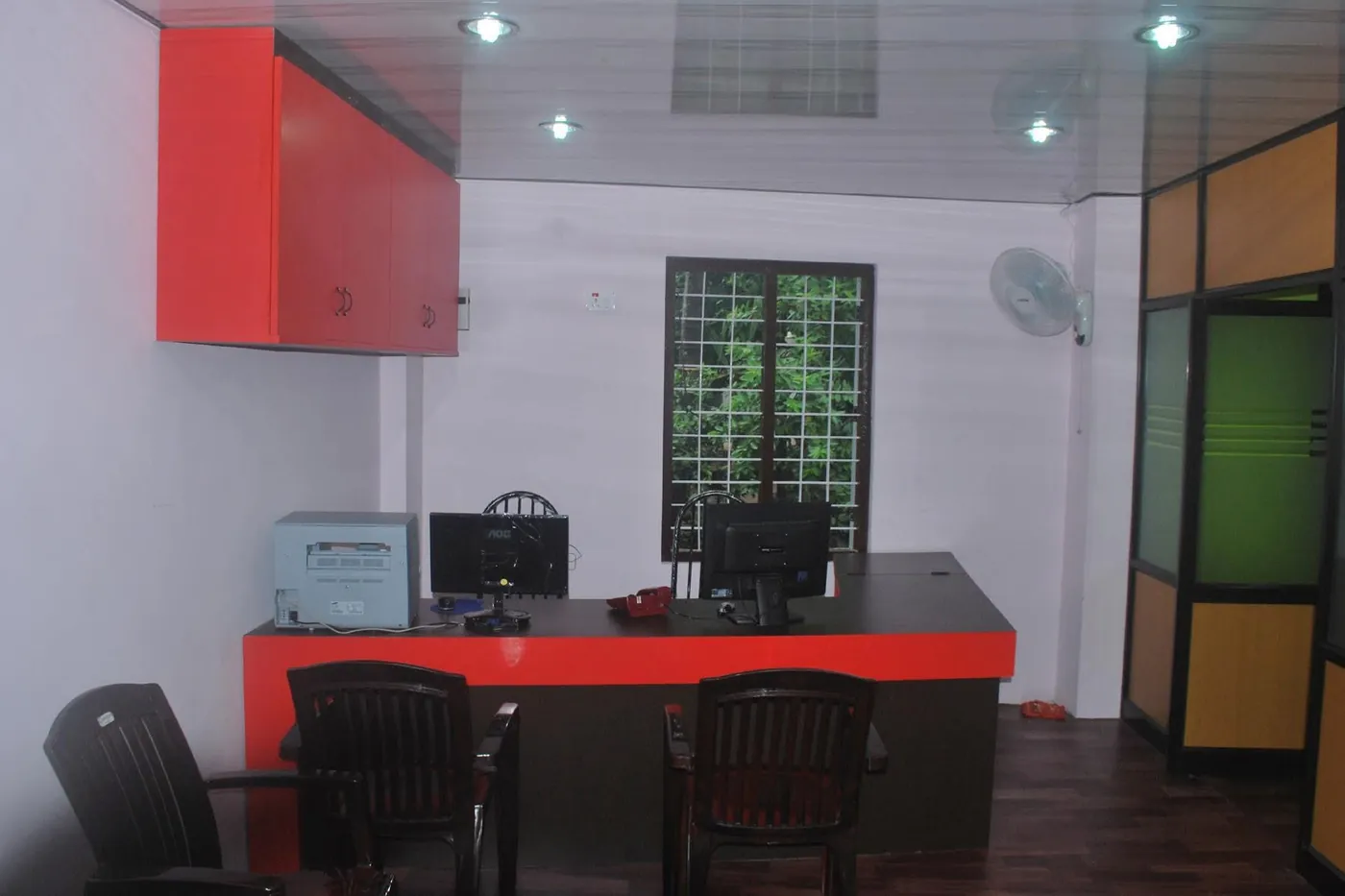 Office front desk with computers and red cabinets
