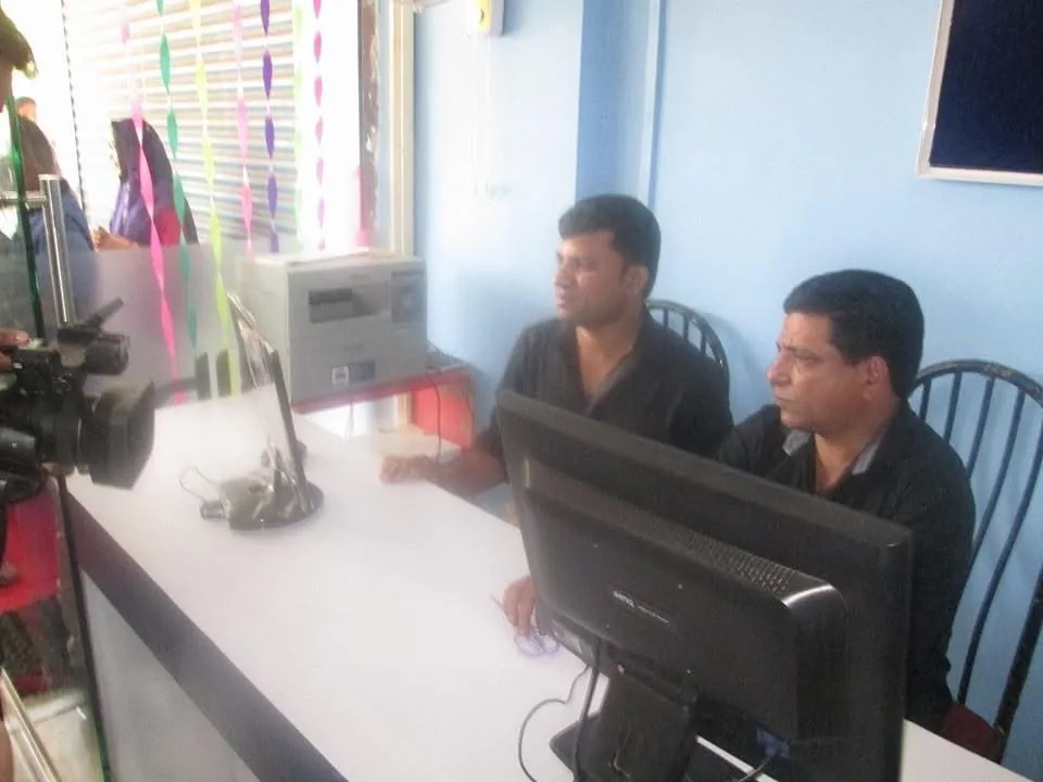 Two men working at the NIB Associates office desk