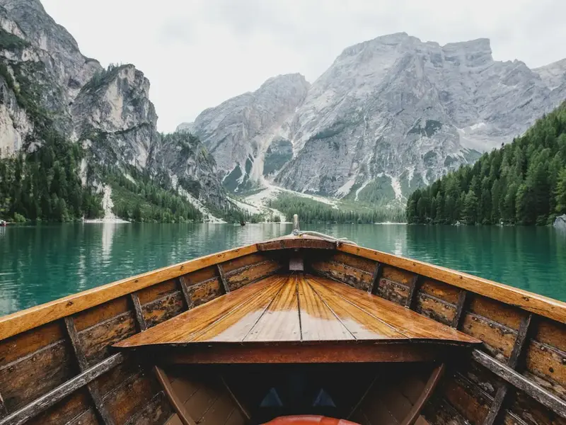Wooden boat on a calm mountain lake