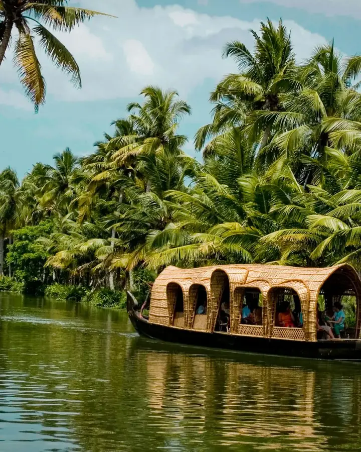 Houseboat among coconut palms on Alleppey backwaters