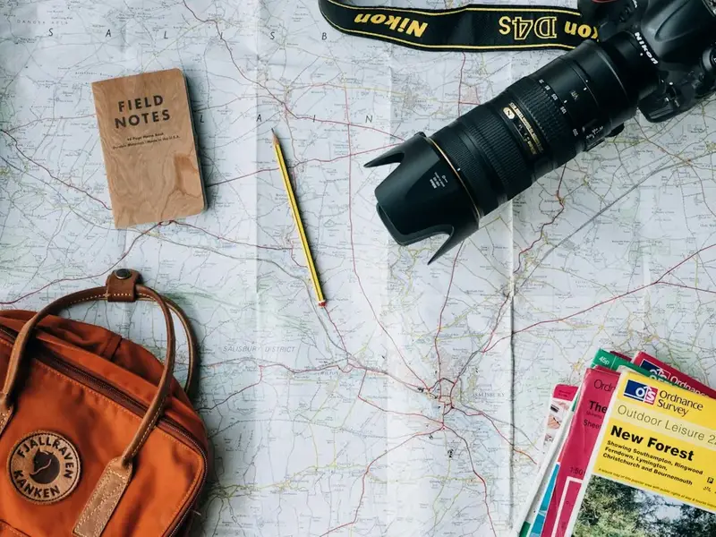 Travel map, notebook and camera