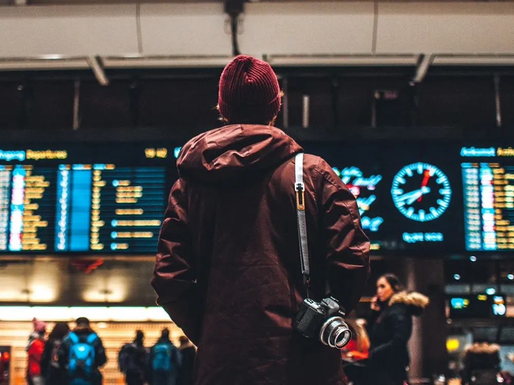 Traveller looking at an airport departures board
